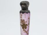 a small glass vase with a flower inside of it