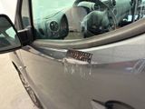 a close up of a car ' s door handle with a sticker on it