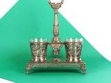 a silver plate with three glasses on it