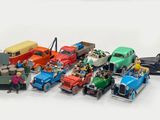 a lot of toy cars that are on a white surface