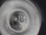 a close up of a silver vase with a coin in it