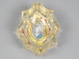 a gold ring with a picture of a woman inside of it