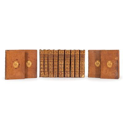a group of books sitting on top of each other on a white surface
