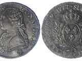 a silver coin with an image of a woman wearing a crown