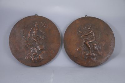 pair of bronze medallions depicting a man and a woman on a horse