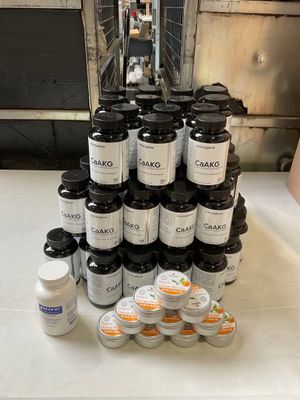 a stack of jars and containers on a table