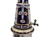a blue and white coffee pot on a stand