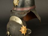 an old helmet with a star on it sitting on a black surface