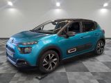 a blue citrole parked on a checkered floor