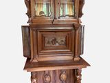 a wooden cabinet with a glass door on top of it