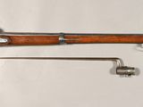 a rifle that is on display on the wall
