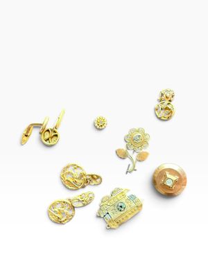 several different types of gold and silver jewelry on a white surface