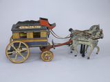 a toy horse pulling a carriage with a man on it