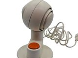 a white object with a red button on it