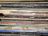 a lot of records in a box on the table
