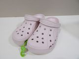 a pair of pink crocs that are on a table