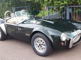 a green sports car parked on the side of the road