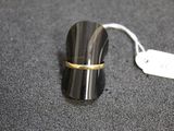 a small black object with a gold band on it