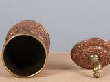 two vases that are sitting on a wooden table