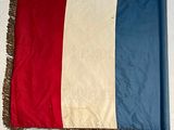 a red, white, and blue flag hanging on a wall