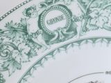 a green and white plate with a picture of a man and a woman on it