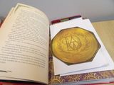 an open book with a picture of a gold medal on it
