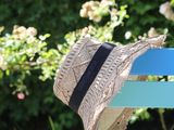 a hat that is sitting on a bench in the garden