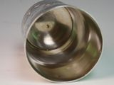 a silver cup that is sitting on a table