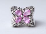 a close up of a pink flower with white diamonds on a white background