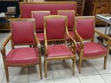 six red leather chairs are lined up in a room