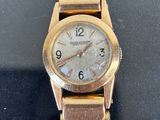 an image of a close up of a wrist watch on a table
