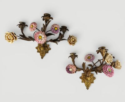 pair of antique wall sconces with flowers and birds on them