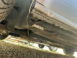 a close up of a car ' s exhaust pipe on the ground