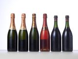six bottles of champagne lined up in a row