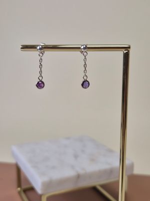 gros plan d'une paire de boucles d'oreilles sur un support