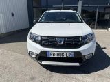 the front end of a white dacia parked in front of a building