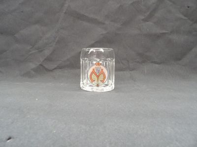 a small glass candle holder on a black background