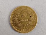 a close up of a gold coin on a white surface