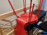 a desk with a red chair and a black chair