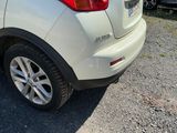 a white car that is parked on the side of the road