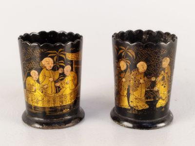 pair of black and gold vases with asian scenes on them