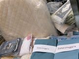 a pile of bedding and pillows on the floor