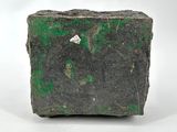 a close up of a piece of rock with green paint on it