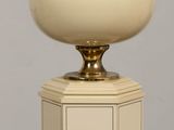 a lamp that is sitting on a table in front of a wall