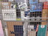 a metal cart with many items in it on the floor