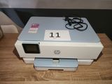 a printer sitting on top of a table with a number on it
