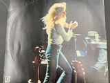 an image of a picture of a woman on stage with a microphone