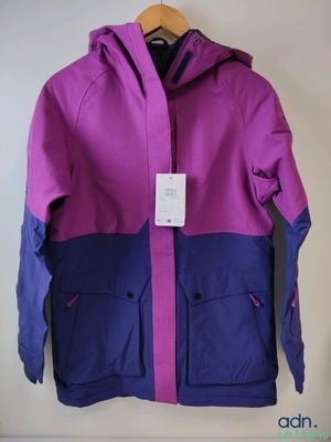 a close up of a purple and blue jacket hanging on a wall