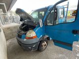 a blue van with its hood open sitting in a parking lot