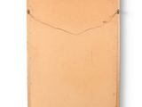 an old book with a brown cover sitting on top of a white surface